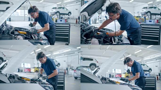 男技工在汽车修理厂对汽车发动机进行诊断试验