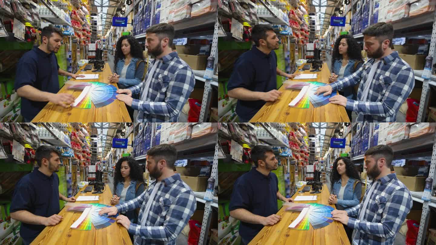 一对夫妇在五金店买了一罐油漆，一边看颜色样品，一边向售货员咨询