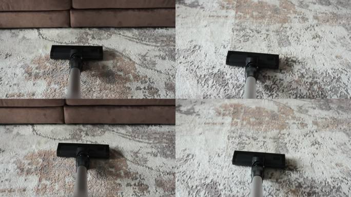 家用吸尘器清洁地毯。吸尘地毯地板的特写镜头。现代家用电器。