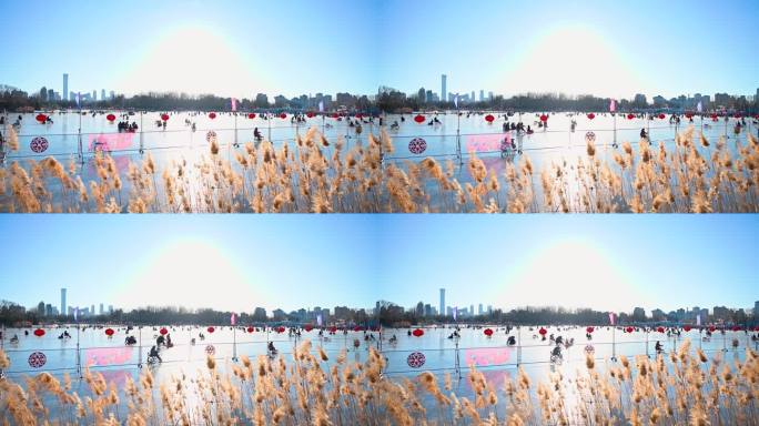 北京冬季阳光下朝阳公园冰场滑冰的人群