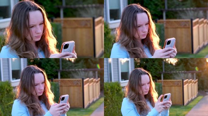 日落时分，一个女孩用手机严肃地站着看社交网络消息通知寻找地理位置许多技术和小工具功能天气预报时间日期