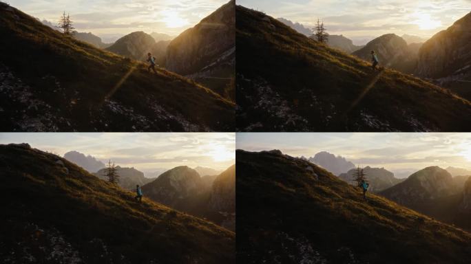 SLO MO女徒步者在阳光明媚的日子跑在芒加特山的草坡上