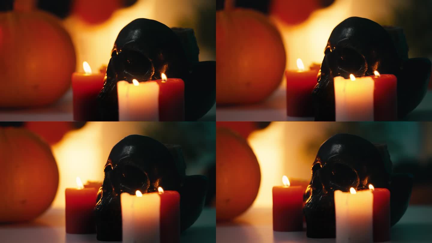 燃烧的蜡烛站在装饰黑色骷髅旁令人毛骨悚然的万圣节气氛