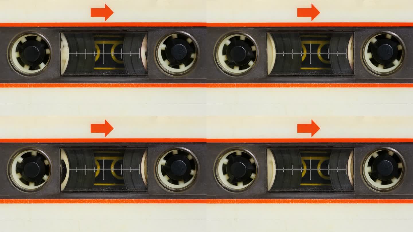 微距静态相机视图的老式音频盒式磁带与白色标签在使用播放盒式磁带机。所有的殴打，灰尘和褪色的标签颜色。