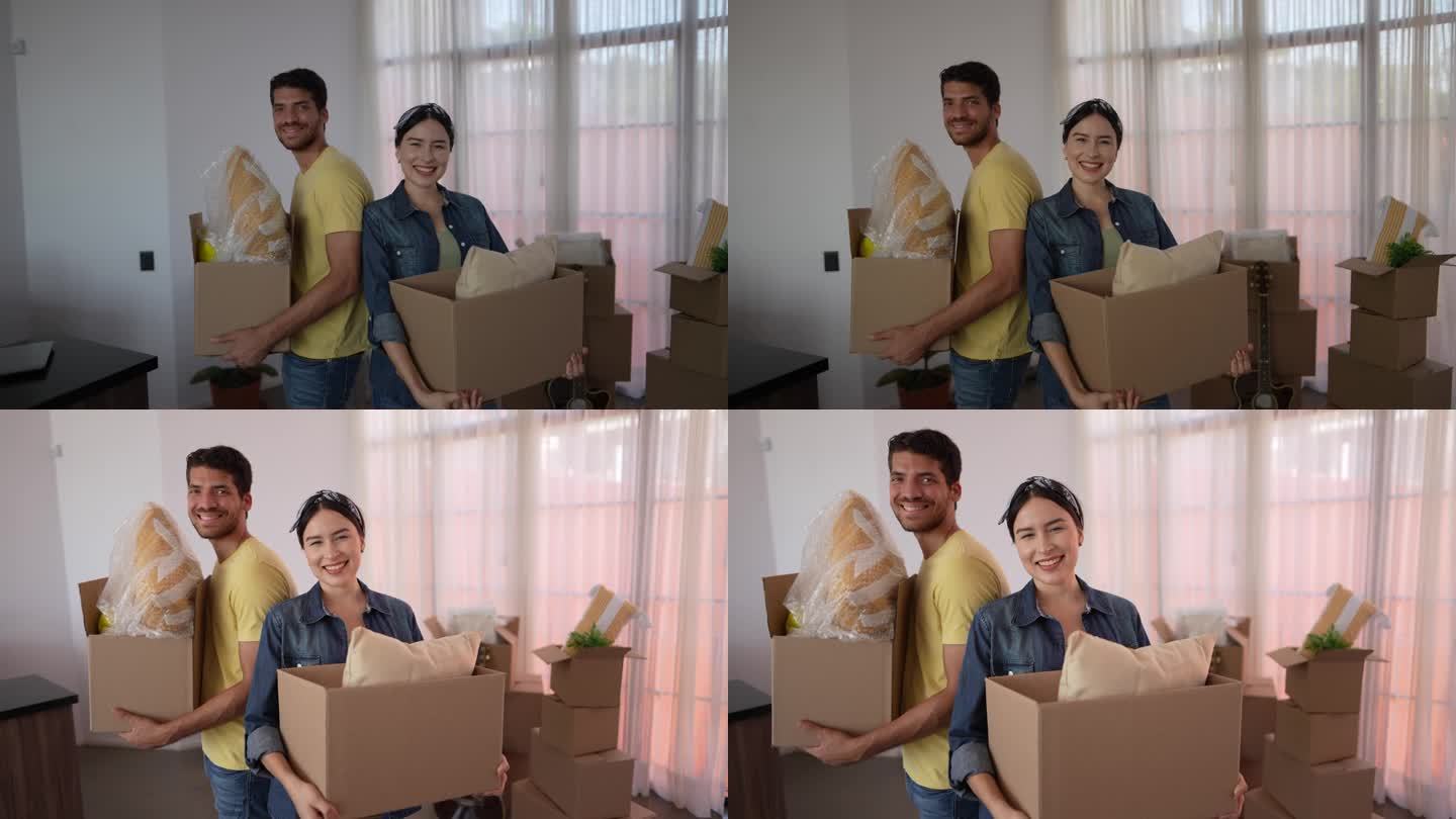 一对年轻夫妇在新房子里搬箱子的照片