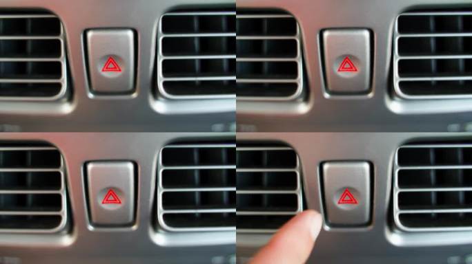 一只手按下汽车中的危险警告灯按钮，特写。道路上不可预见的情况，警告故障或停车