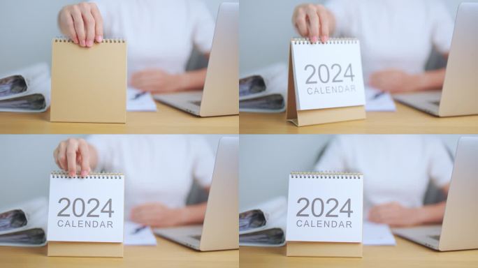桌上放着2024年日历，商务女性在用笔记本电脑。倒计时，新年快乐，决心，目标，计划，行动，使命和财务