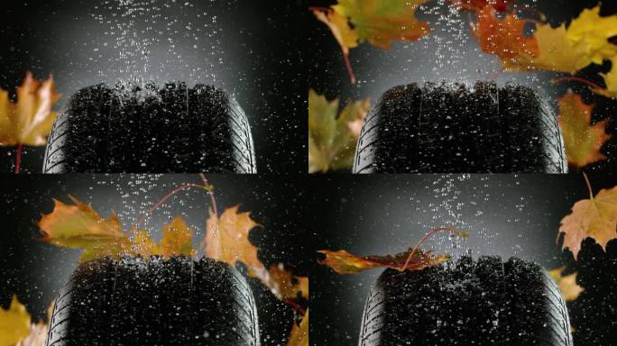 轮胎样品上的雨滴和秋叶的超慢动作