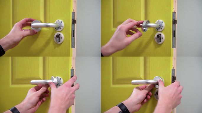 一个戴着手表配件的商人正在给一扇绿色的门安装一个银色的门把手
