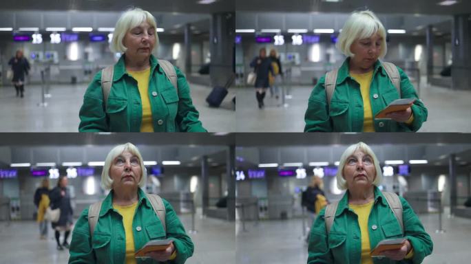白种金发的老年女性，在国际机场拿着护照和登机护照，在航班问讯处查询航班