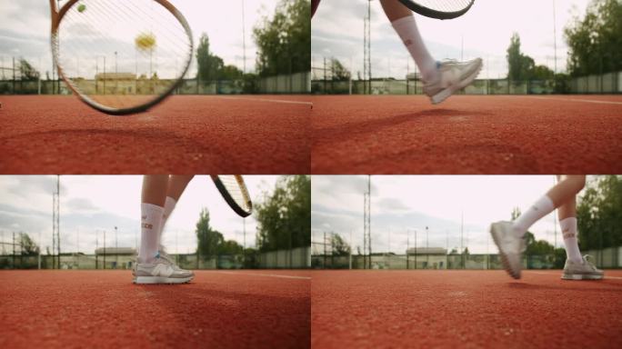 女子网球运动员用球拍从场上拿起球发球。