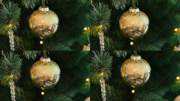 圣诞饰品背景。金色和白色装饰玻璃小玩意。圣诞树上有地球仪、泡泡。闪闪发光的球，圣诞树枝。装饰物品。冬