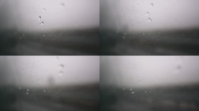 雨滴落在驾驶汽车的侧窗玻璃上。在雨中开车