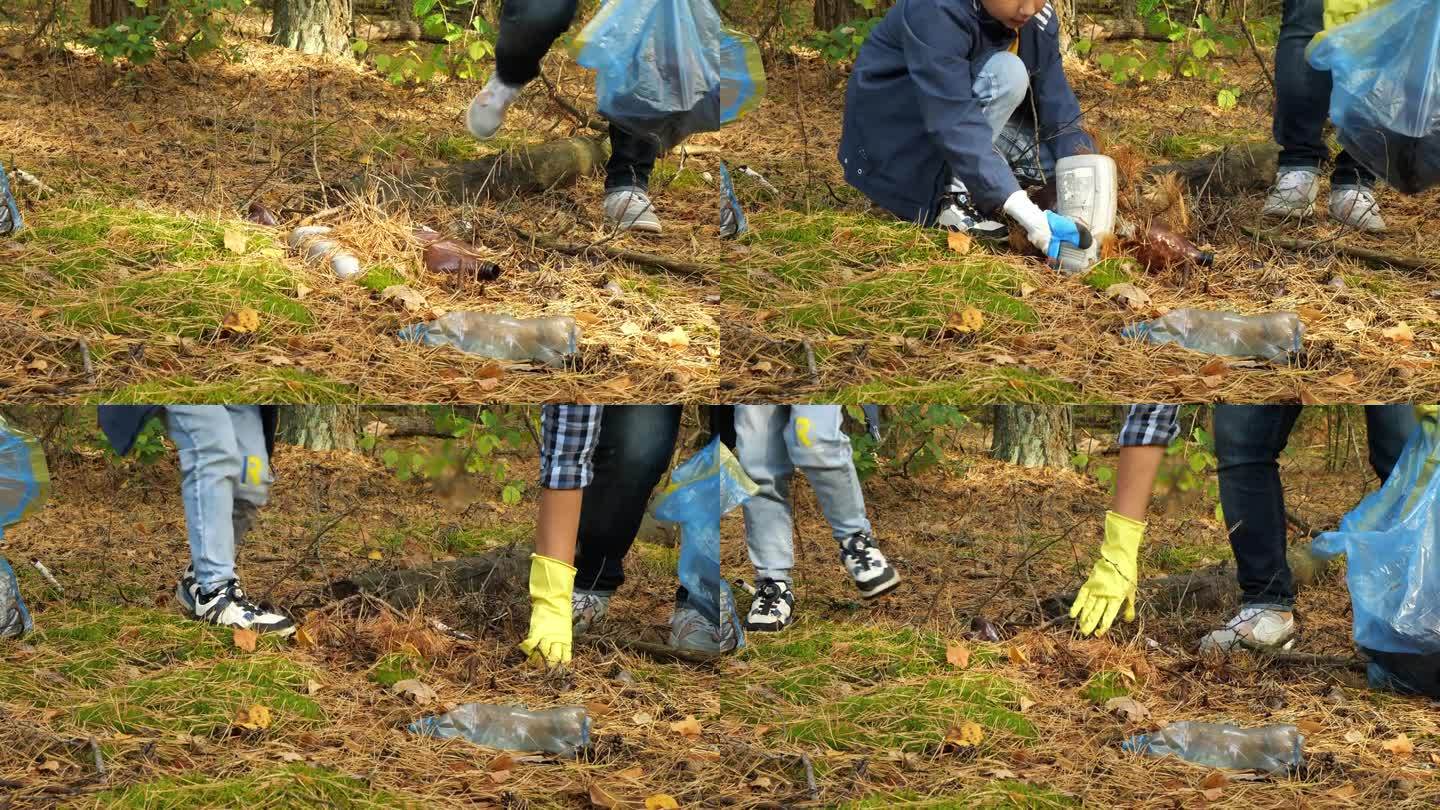 母亲和孩子在森林里捡垃圾。一位妇女和她的儿子用袋子收集森林免受污染。从垃圾中拯救地球的概念。