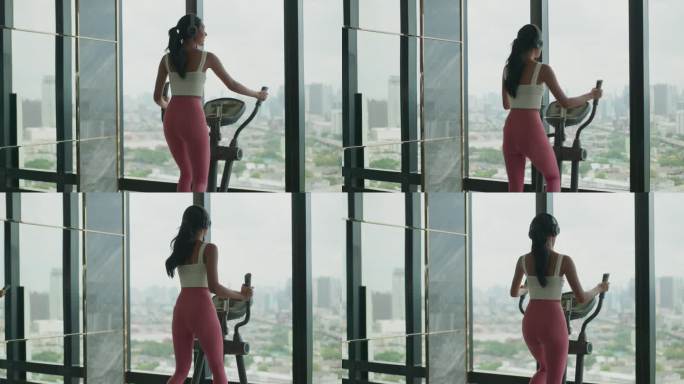 年轻健康的亚洲女性在市中心风景优美的健身俱乐部使用椭圆交叉训练机进行锻炼。无忧无虑的亚洲女性在室内进