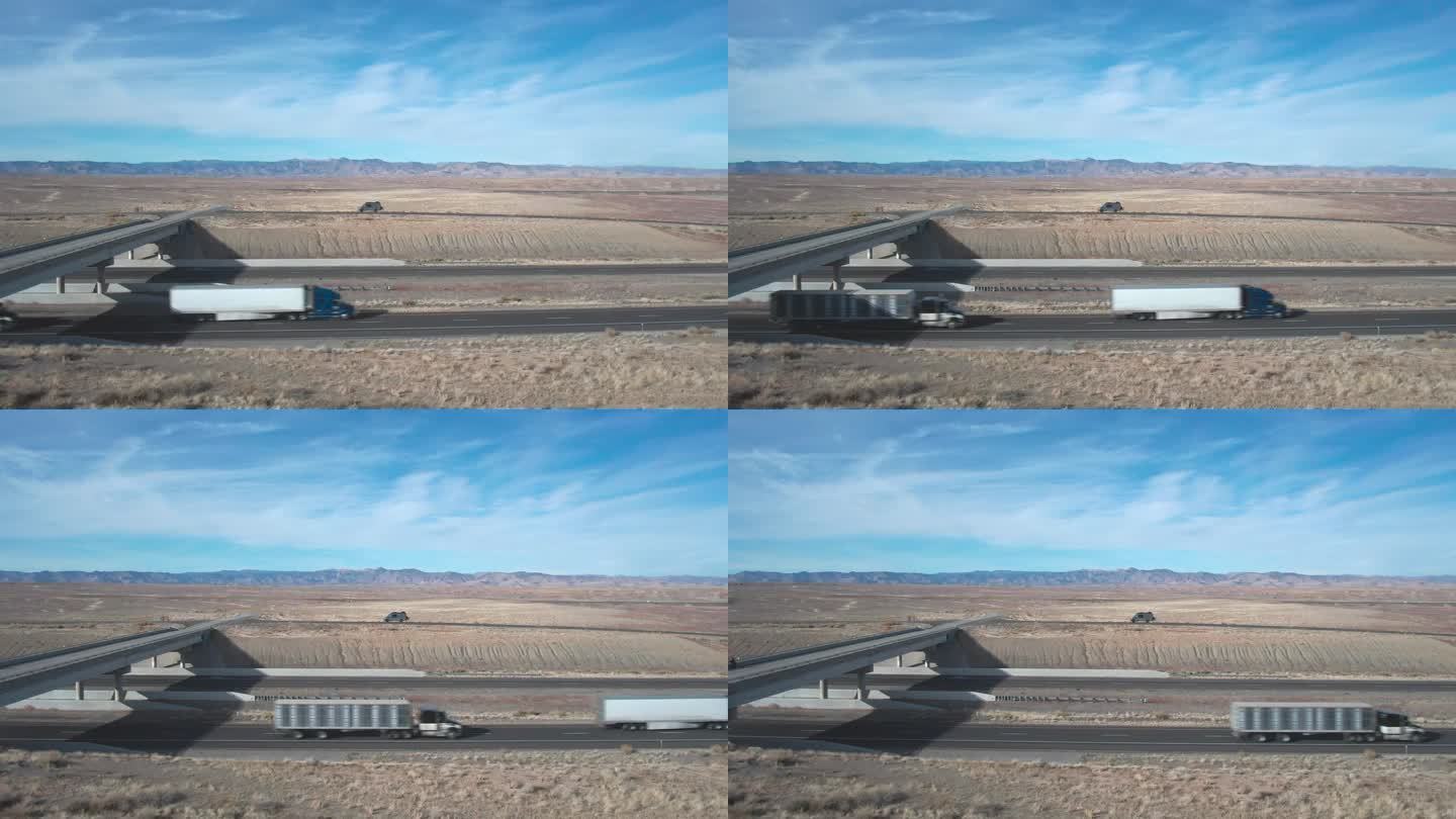 无人机拍摄的两辆半卡车经过I-70在犹他州在一个阳光明媚的冬日