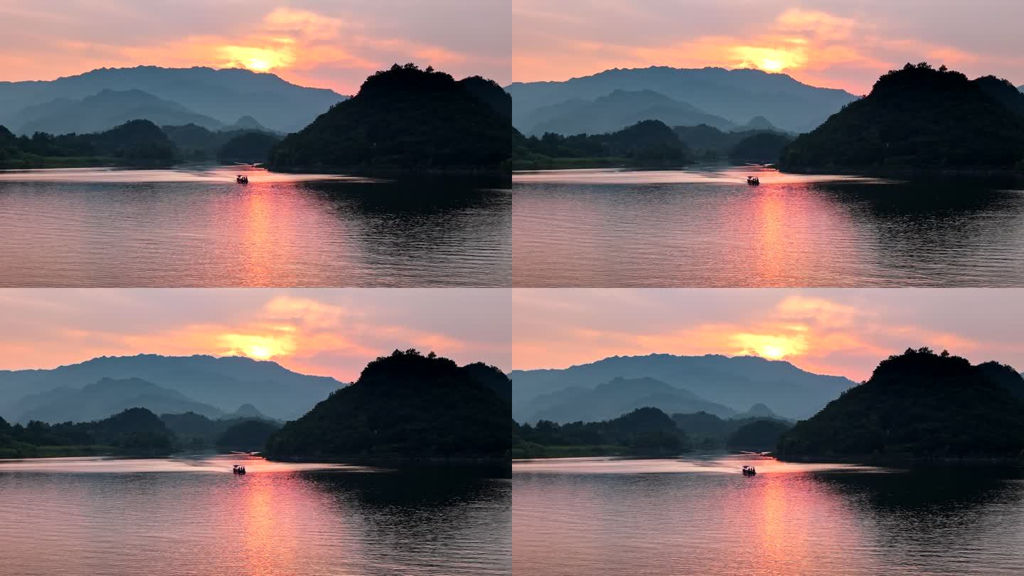 夕阳下湖面迎面驶来的小船