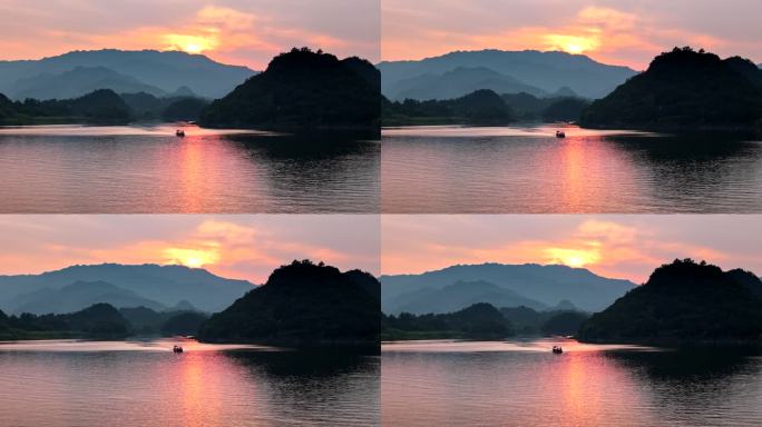 夕阳下湖面迎面驶来的小船