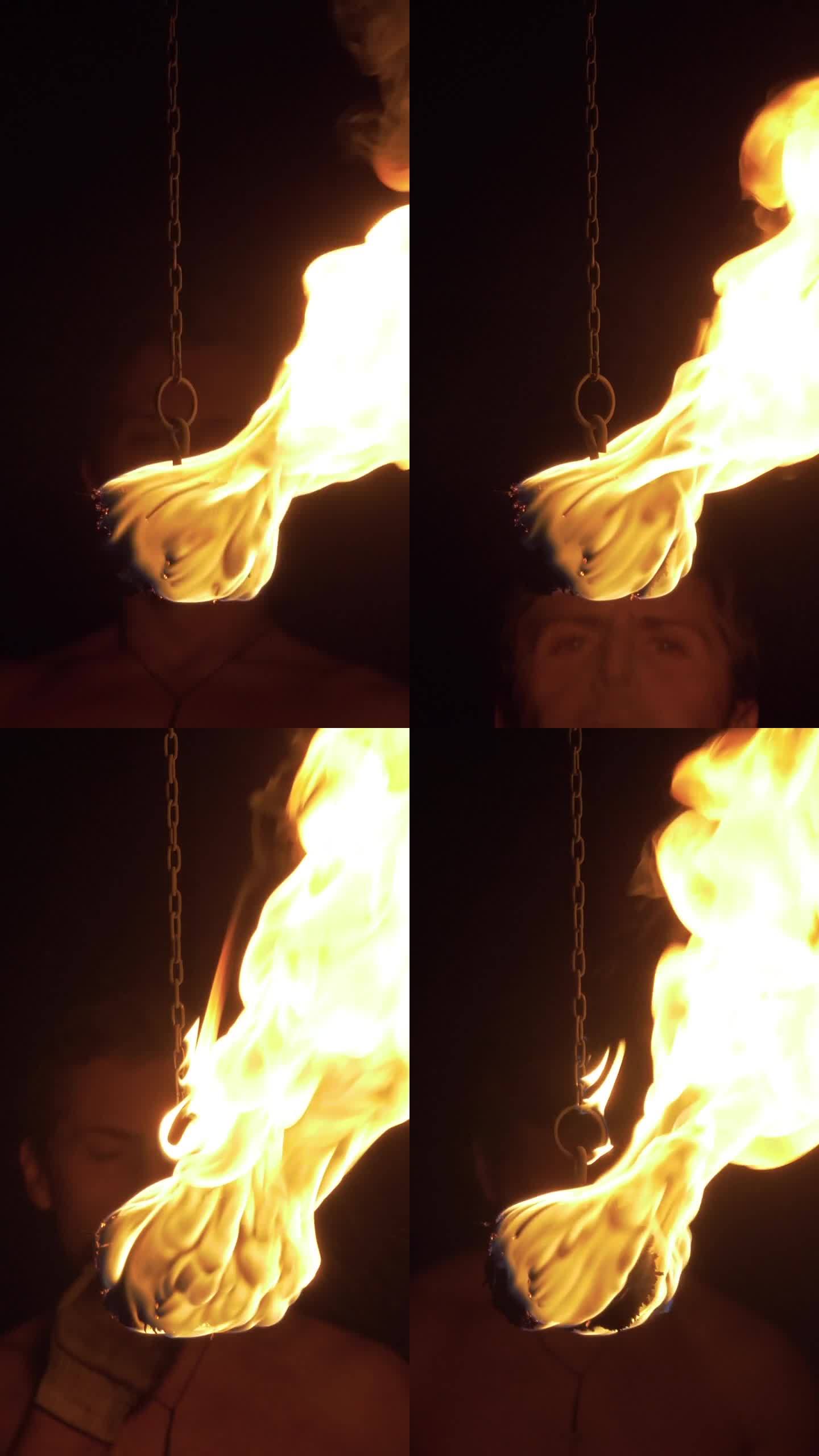 一名男子在靠近摄像机的地方喷出火云。火焰喷发并燃烧。垂直视频
