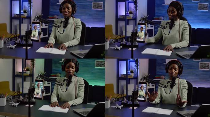 微笑的有影响力的非洲妇女坐在手机摄像头前录音