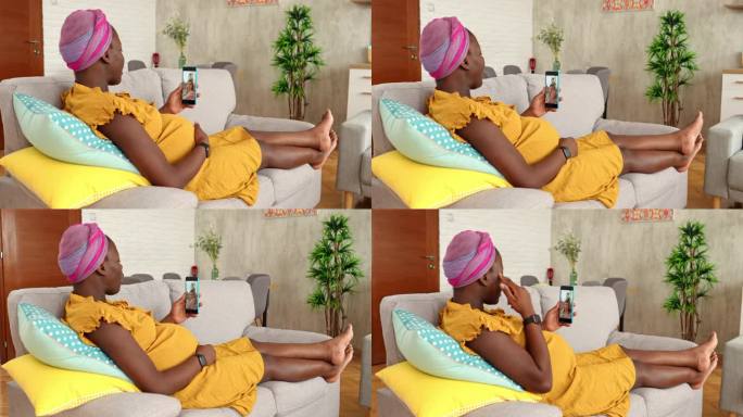 怀孕的黑人妇女在家里和朋友视频通话