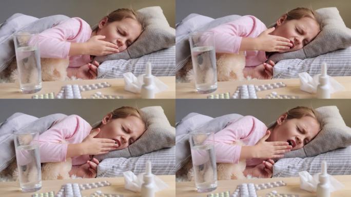 热解脱。儿童医疗保健。国内经济的复苏。不健康的女婴穿着家服躺在床上困倦地打着哈欠，用手捂着嘴。