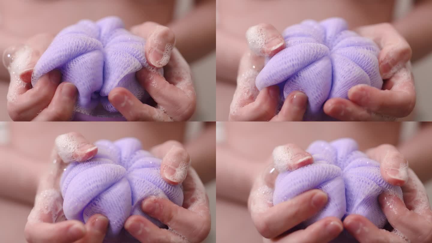 女人手里拿着紫色丝瓜络和肥皂，特写