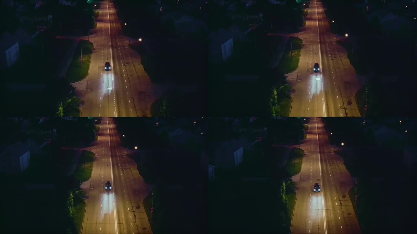 夏天，郊区的夜晚，汽车驶过城市街道上的减速带。无人驾驶飞机。