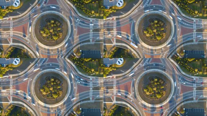 城市街道交通的俯视图在环形交叉路口与快速移动的汽车。城市循环交通十字路口延时图