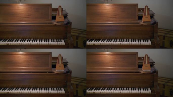 古色古香的木制节拍器在老式的棕色钢琴上以每分钟60拍的速度摆动