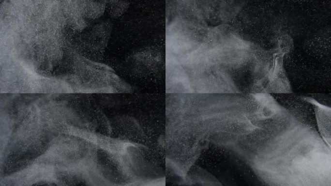 灰尘颗粒在黑屏上以慢动作爆炸。大气覆盖。用RED摄影机拍摄