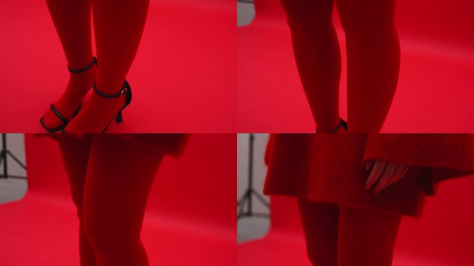 一个穿着红色紧身衣的女孩的腿，红色的背景，红色的毛衣。艺伎在摄影棚里摆姿势