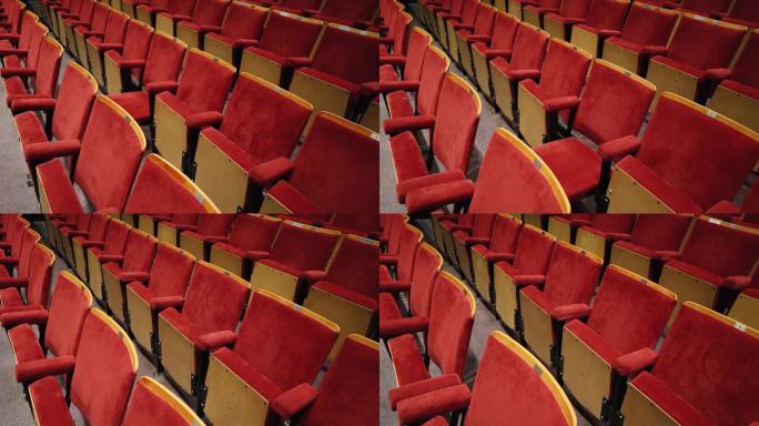 沿着老电影院礼堂一排排红色座位的移动