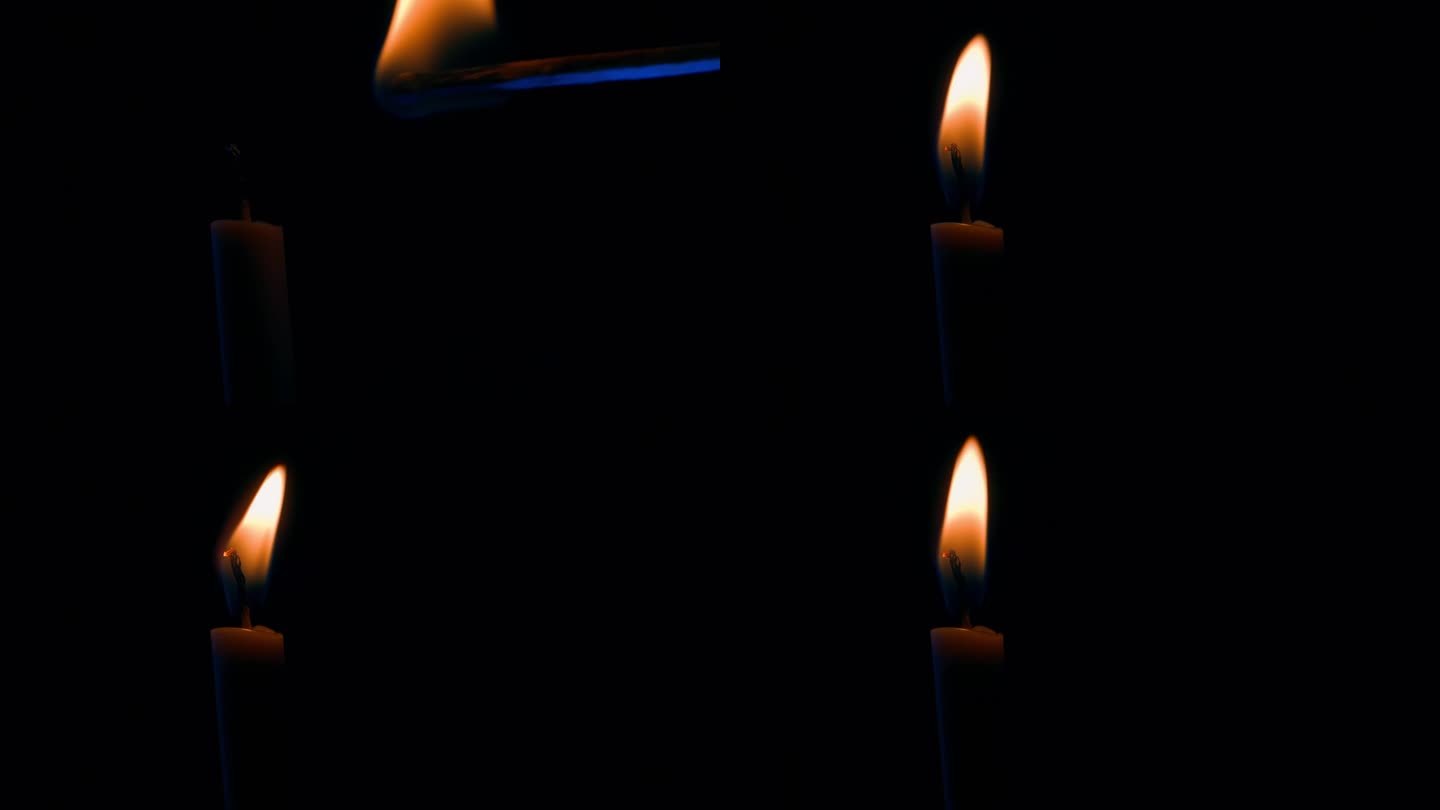 在完全的黑暗中，用火柴点燃蜡烛，特写。燃烧的蜡烛芯被吹灭了