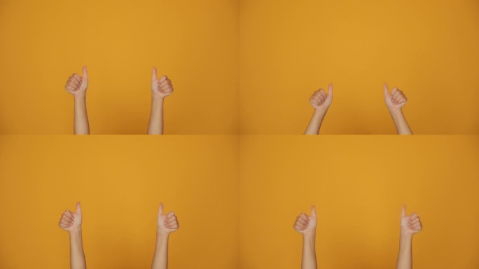 为点赞点赞。手在橙色的背景上做手势。