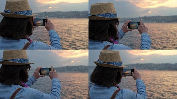 日落时分，年轻女子在伊斯坦布尔的桥上拍照
