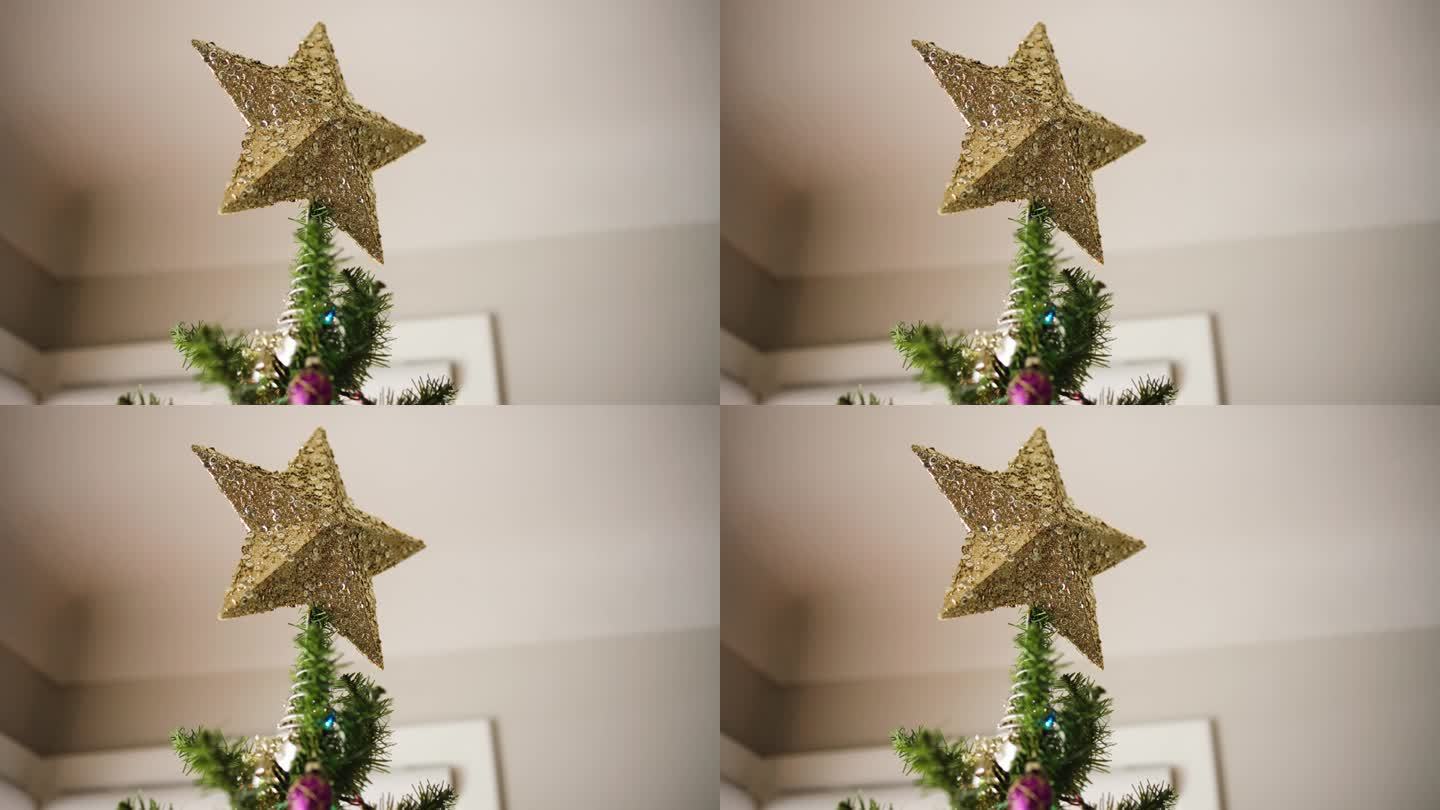 金色的圣诞之星，树顶饰与亮片。静态，浅焦点