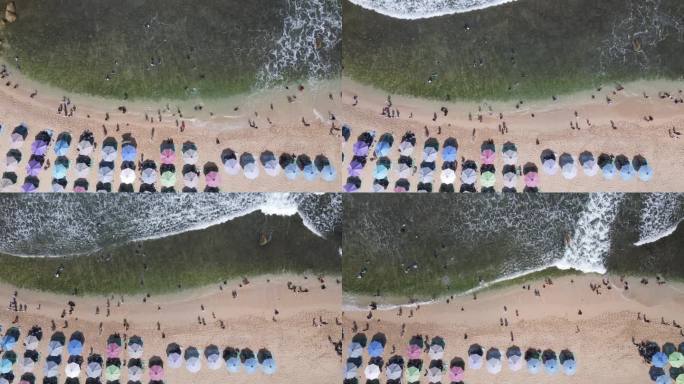 空中无人机拍摄的假期在印尼的古农海滩，有大海、船和人。