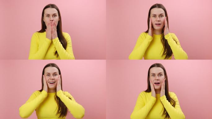 25岁的年轻女性穿着黄色的毛衣，在摄影棚的粉红色背景墙上独自摆姿势，惊讶地张大嘴巴，竖起大拇指，表现