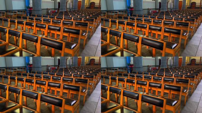 在比利时天主教堂，一排供观众、教徒和礼拜者使用的椅子