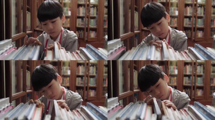可爱又聪明的亚洲小学生在学校图书馆的木书架上找书