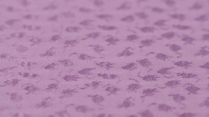 旋转素色提花织物丁香色特写。宏纹理工厂材料编织图案。
