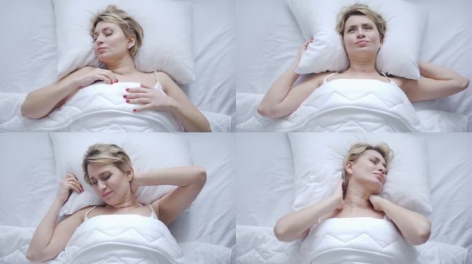 不开心的女人躺在床上，头、脖子和肩膀感到疼痛和不适，因为廉价的枕头不舒服，睡眠条件不好，缺乏矫形床上