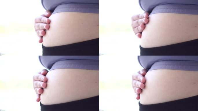 肥胖的亚洲年轻女性穿着运动服，肚子大，暴饮暴食，肥胖。体重:身体脂肪超过理想值的人，身体质量指数(B