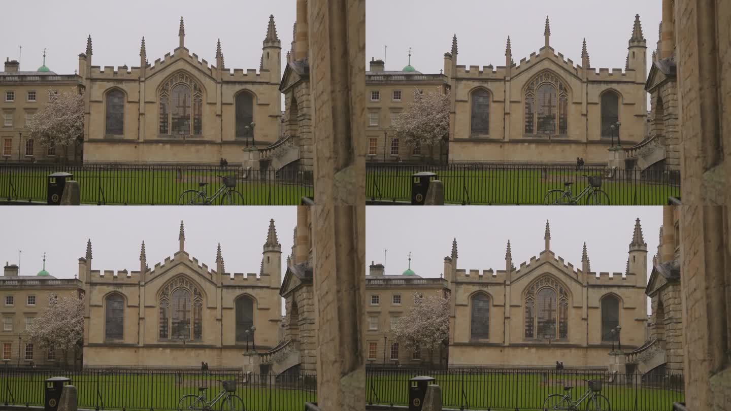下雨天，牛津大学学院校门旁的学生自行车站着。学习牛津大学的教育理念