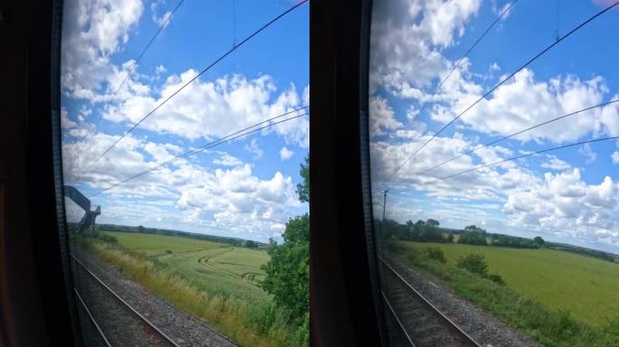 POV VERTICAL:在阳光明媚的日子里，火车穿越风景优美的英国乡村