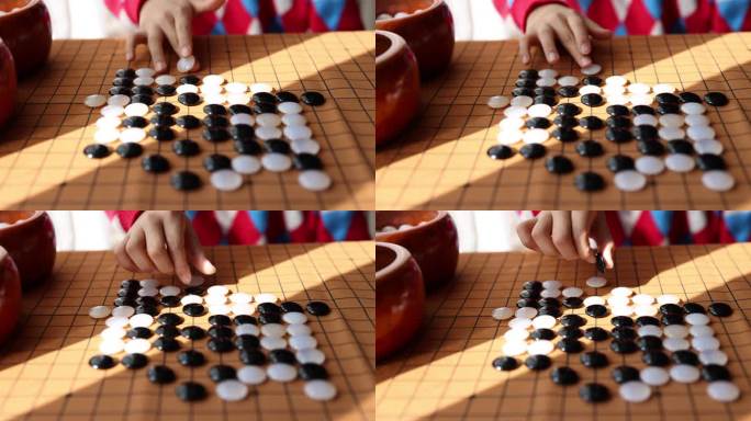 中国小孩在窗边下棋围棋手部特写