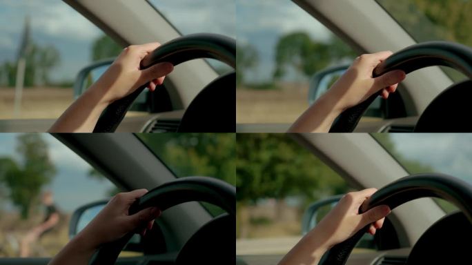 日落时分开车的女司机手握方向盘