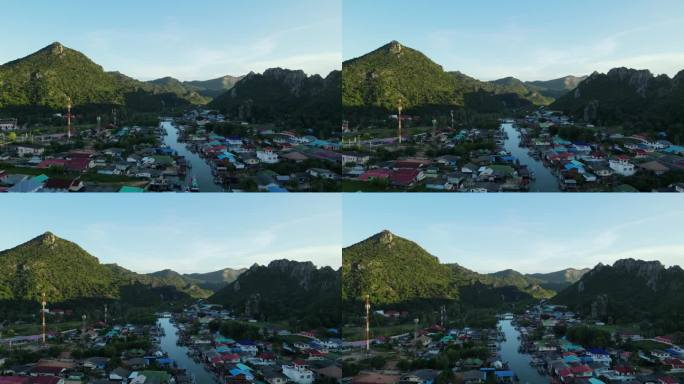 无人机飞向风景如画的风景，而Bang Pu渔村被山脉的阴影所覆盖，泰国，Prachuap Khiri