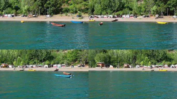 航拍晴天泸沽湖上五彩的木船